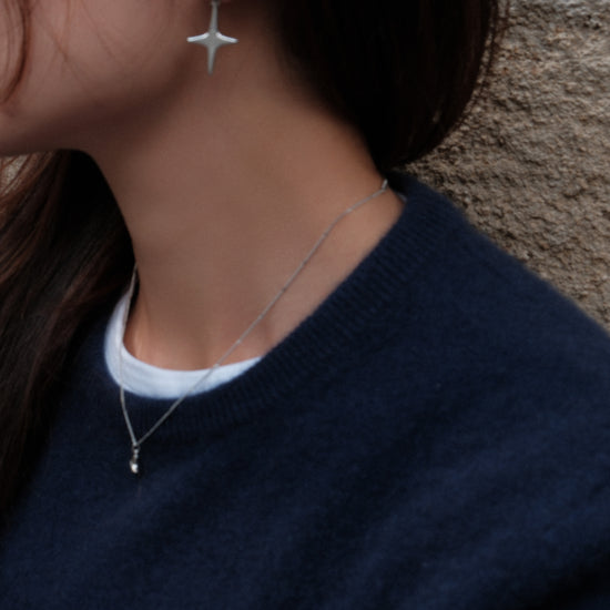 Aretes plateados con diseño de estrella
